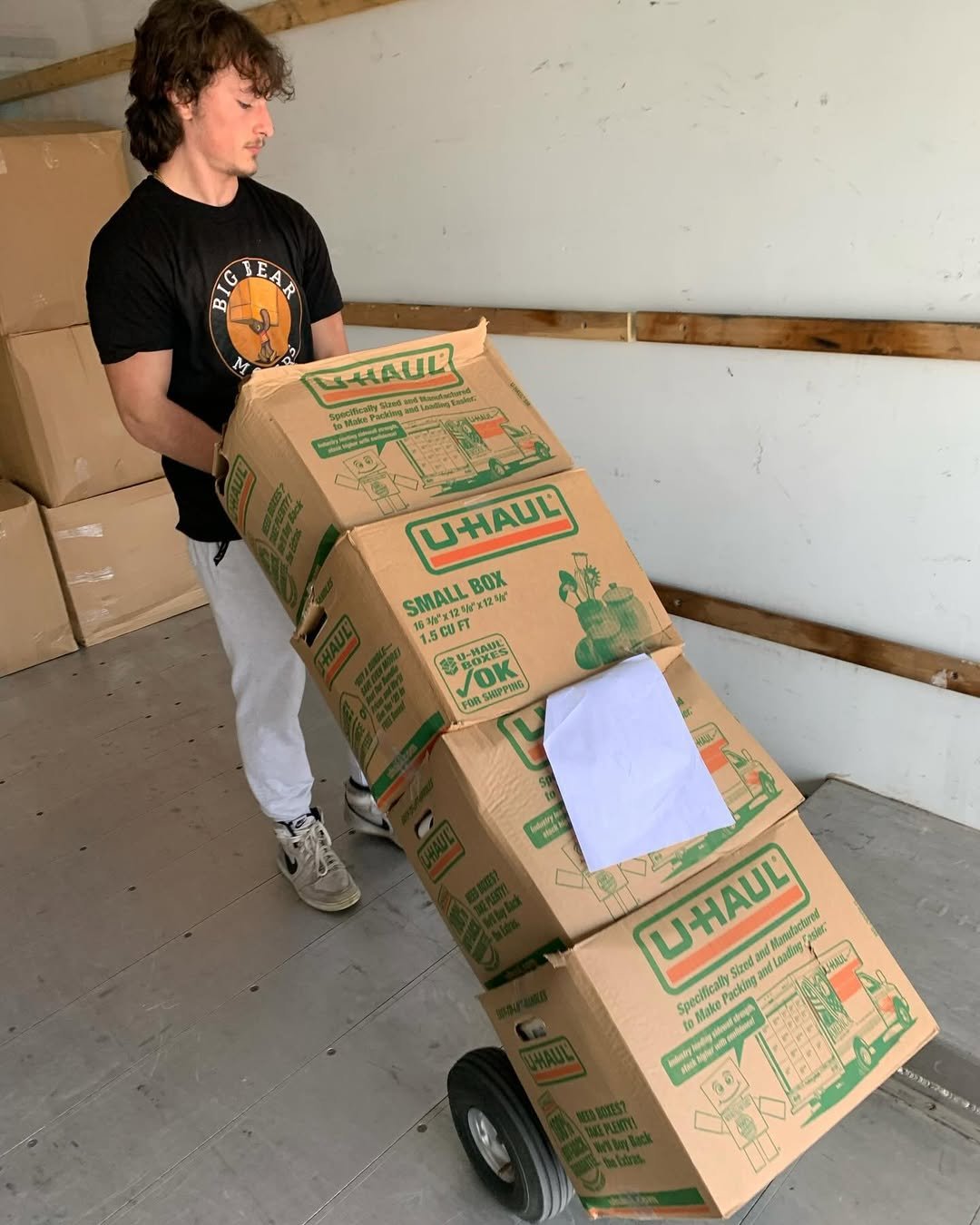 Auburn moving services - Mover transporting boxes on dolly into moving truck - Big Bear Movers Massachusetts