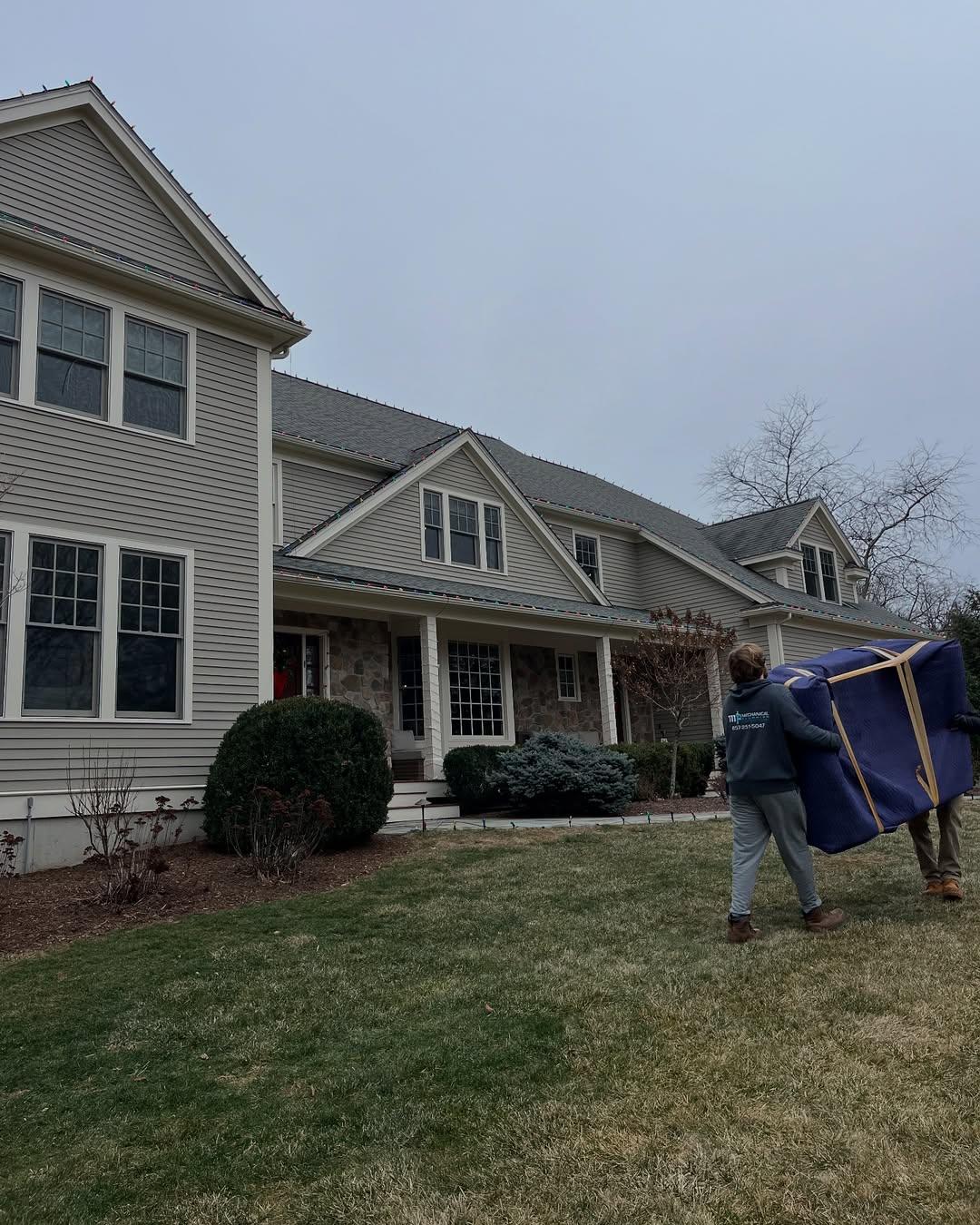 Professional residential moving services Boston MA - licensed movers loading furniture into moving truck Professional residential moving services Boston MA - licensed movers loading furniture into moving truck